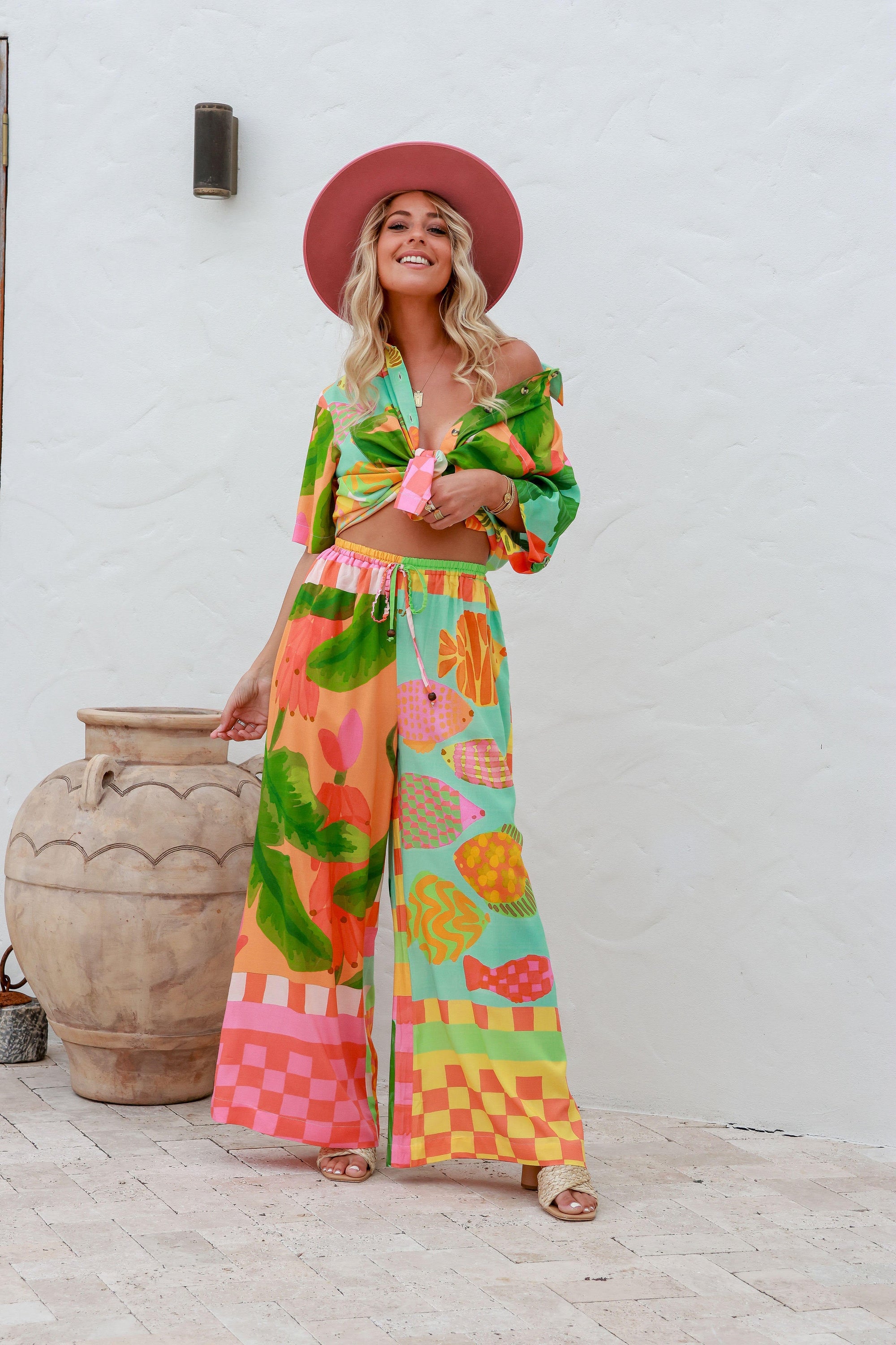 colourful wide leg pant with bananas, fish, pineapples all on an aqua, orange and pink toned background. The essence of summer.